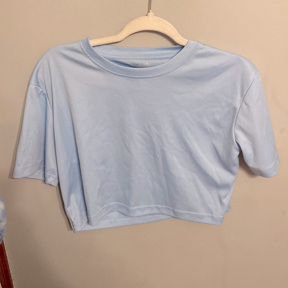 Light blue cropped tee.